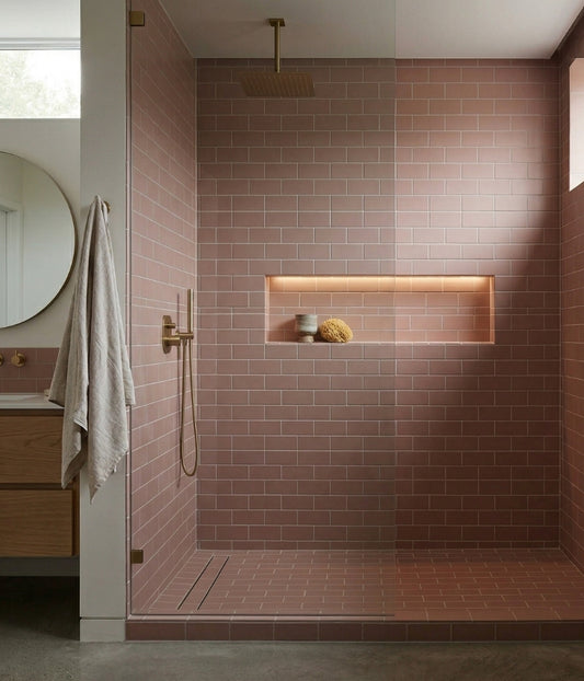 Rosewater Matte 2x5 solid tile by Clay Imports in a subway pattern, with gold fixtures and a lighted recessed niche in a modern shower.