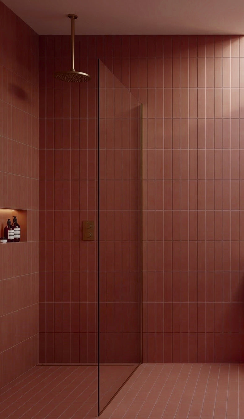 Campfire reddish-brown rectangular clay tiles by Clay Imports in a shower with vertical and horizontal stack bond patterns.