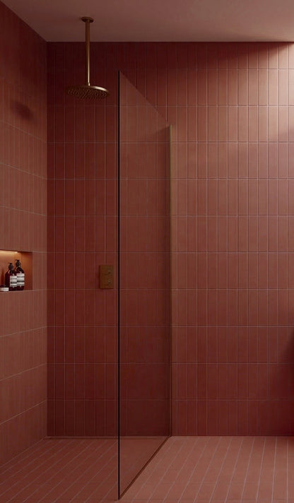 Campfire reddish-brown rectangular clay tiles by Clay Imports in a shower with vertical and horizontal stack bond patterns.