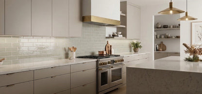Yucca Crackle Gloss 2x8 Solid Tile by Clay Imports, featuring a shiny, light green crackle finish as a kitchen backsplash.