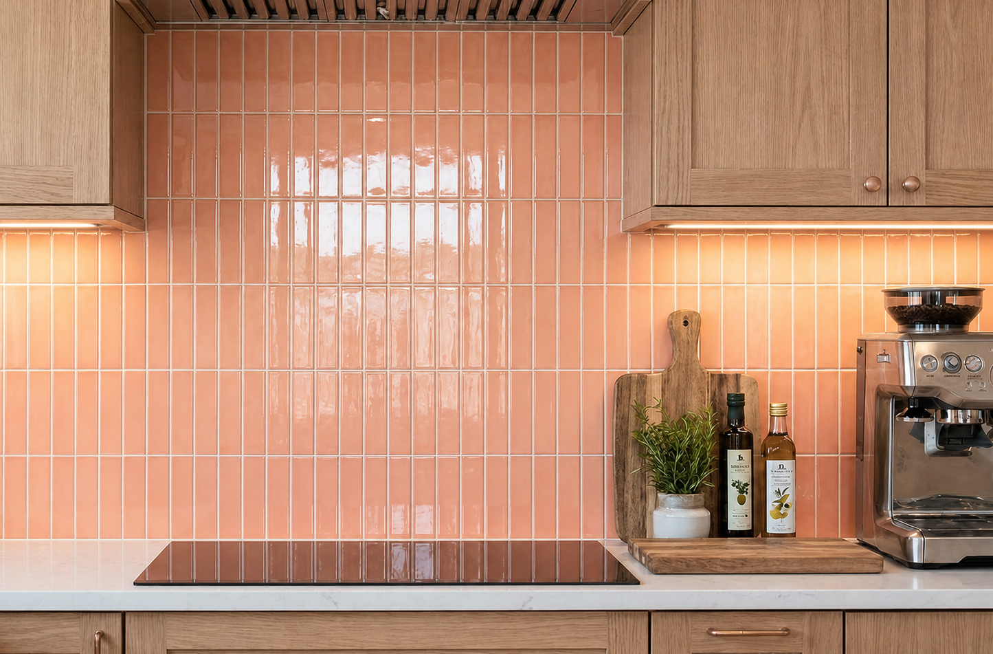 Peach glossy solid tiles by Clay Imports installed vertically as a kitchen backsplash with wooden cabinets.