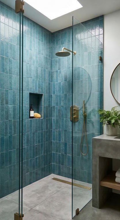Botanical Teal 2.5x8 Glazed Thin Brick by Clay Imports, vertically installed on shower walls with a textured finish and brass fixtures.