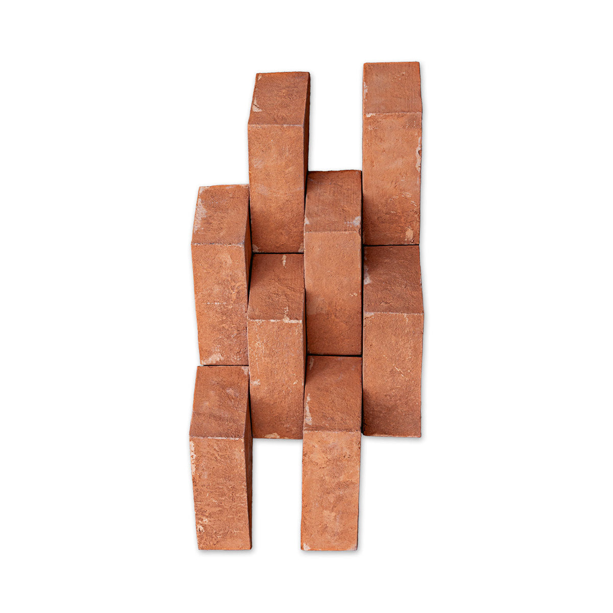 A stack of terracotta clay brick blocks arranged in a staggered, interlocking pattern against a plain white background.