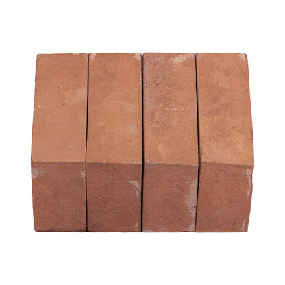 Four rectangular terracotta clay bricks arranged side by side on a plain white background.