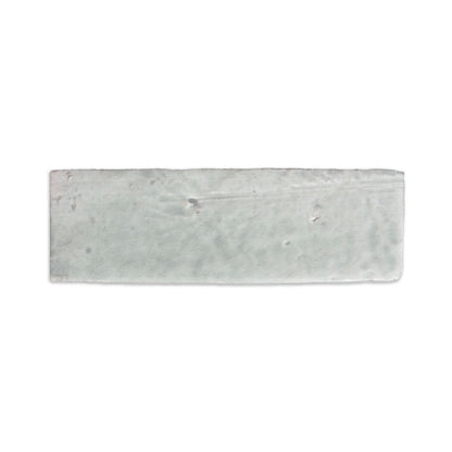 Light grey glazed thin brick by Clay Imports with a crackled texture and irregular edges.