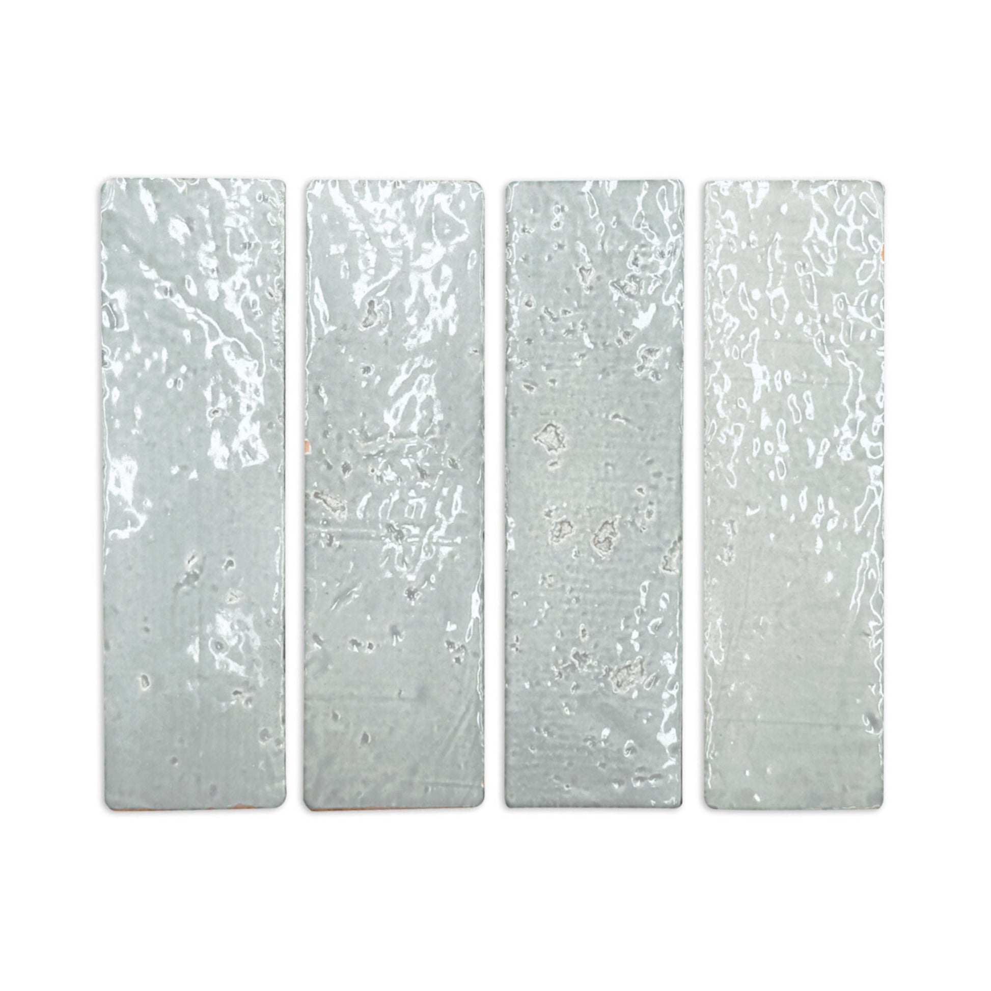 Four light grey glazed thin bricks by Clay Imports with irregular glossy surfaces, arranged vertically.