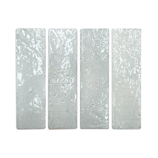 Four light grey glazed thin bricks by Clay Imports with irregular glossy surfaces, arranged vertically.