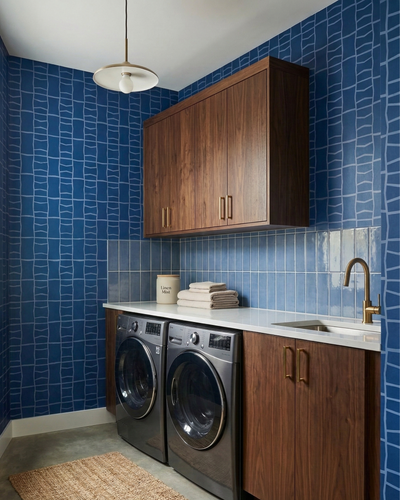 Blue rectangular solid tile by Clay Imports, arranged vertically as a glossy backsplash in a modern laundry room.