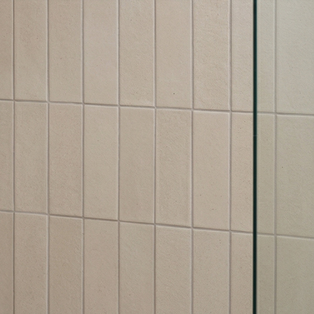 Light beige rectangular solid tile by Clay Imports with a subtle grainy texture and vertical orientation.