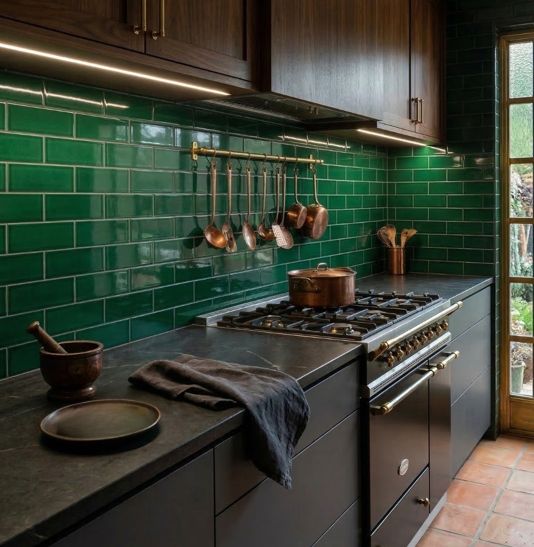 Green glossy solid tile by Clay Imports in a subway pattern on a kitchen backsplash.