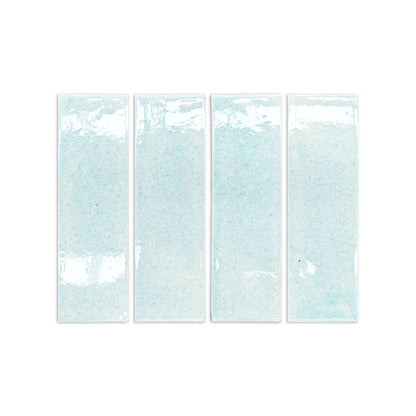 Light blue crackle-glazed rectangular clay tiles with speckled texture and glossy finish, arranged in a row, front view