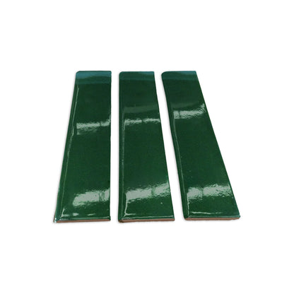 Three glossy Bottle Green 3x12 clay tiles by Clay Imports, arranged side-by-side with visible reddish-brown unglazed edges.