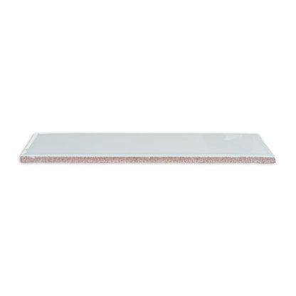 Spearmint green 3x12 solid tile by Clay Imports with a glossy finish and visible reddish-brown unglazed edge, viewed at an angle.