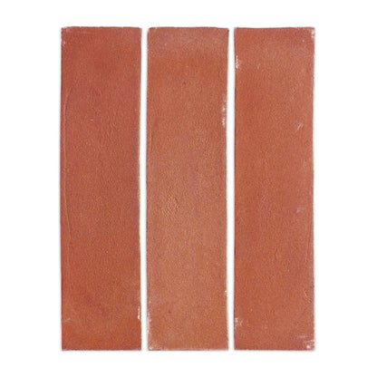 Three rectangular cotto tiles by Clay Imports, reddish-brown with a textured surface and white grout.