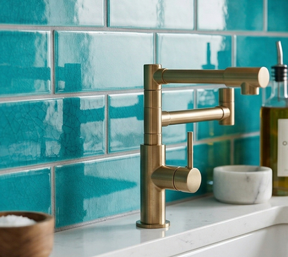 Turquoise crackle subway tiles by Clay Imports, glossy with fine cracks, installed as a kitchen backsplash with a gold faucet.