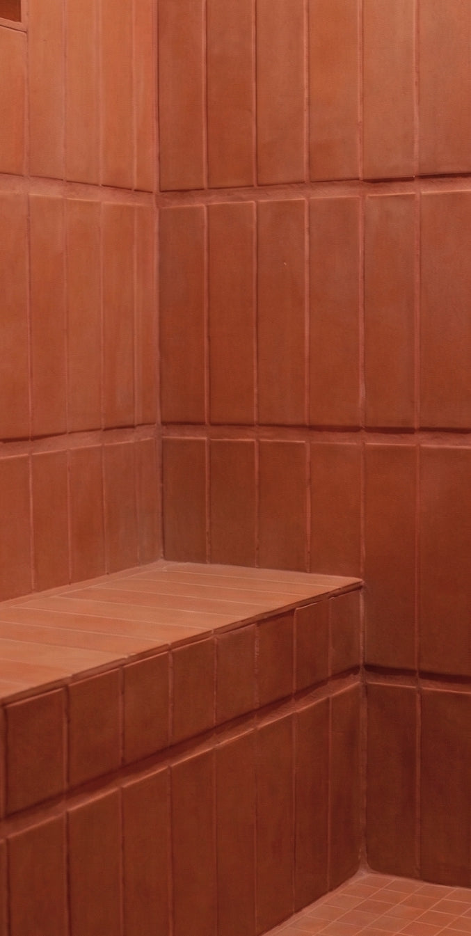Terracotta solid tile by Clay Imports, laid vertically on walls and horizontally on a built-in bench.
