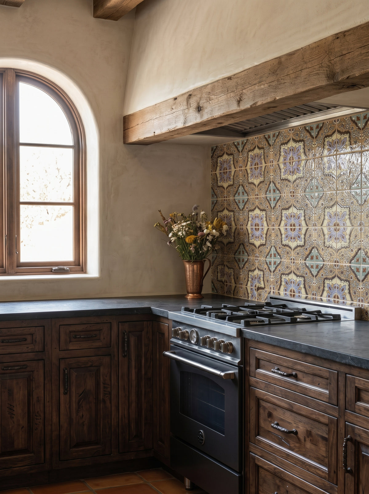 Relief Talavera tile in Bluffs pattern by Clay Imports, with intricate purple, blue, and cream motifs forming a kitchen backsplash.