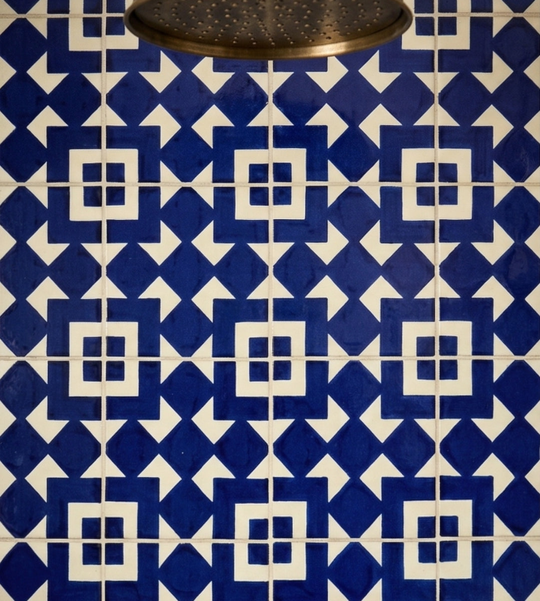 Blue and white Traditional Talavera tile by Clay Imports Handmade Tile, featuring a geometric pattern of interlocking blue diamonds and white squares.