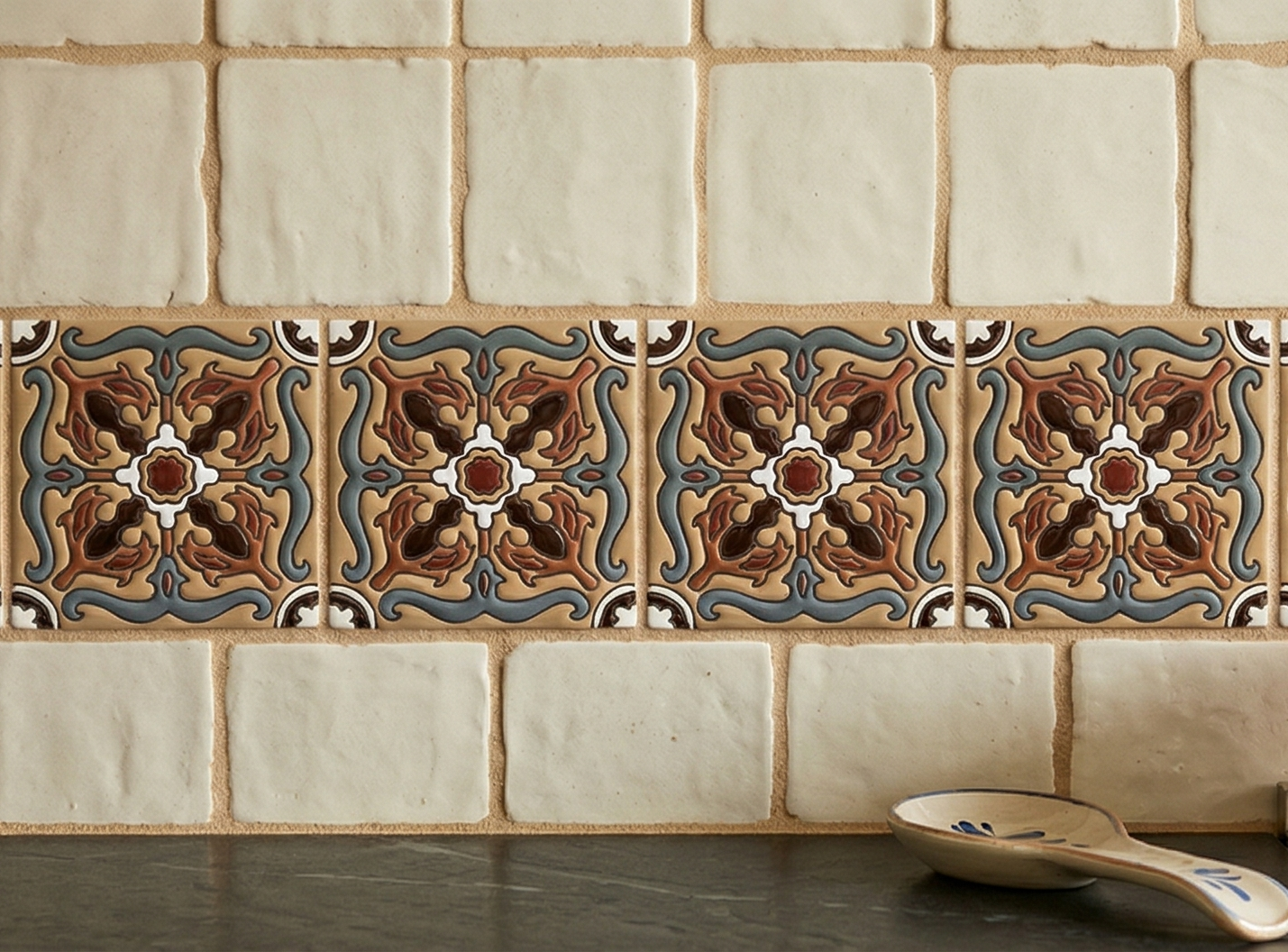 4.25x4.25 embossed Relief Trancas tile by Clay Imports, with an ornate multi-color floral pattern backsplash.