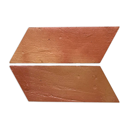 Two left-facing parallelogram terracotta tiles by Clay Imports, reddish-brown with an antique satin finish, arranged as an arrow.