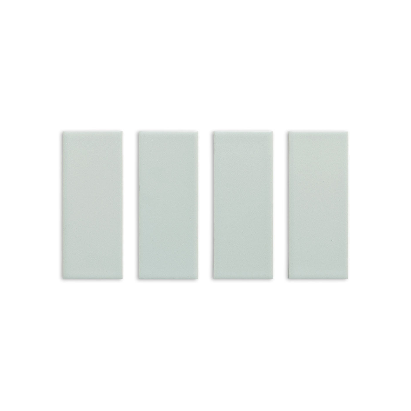 Four Espadin Matte 2x5 solid tiles by Clay Imports in light green with a subtle texture, arranged vertically.