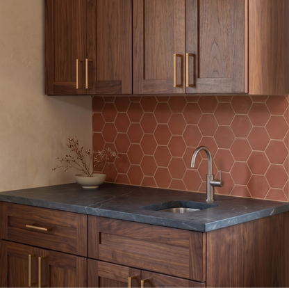 Modern kitchen with wooden cabinets, hexagonal tile backsplash, and a sink.