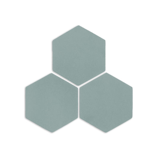 Light blue-green hexagon clay tiles from Clay Imports, three pieces arranged in a cluster with soft shadows.