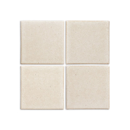 Four light cream Pearl Snap solid tiles by Clay Imports, featuring a matte, subtly speckled texture.