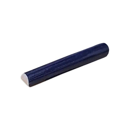 Dark blue half-round pencil liner tile by Clay Imports, viewed at an angle.