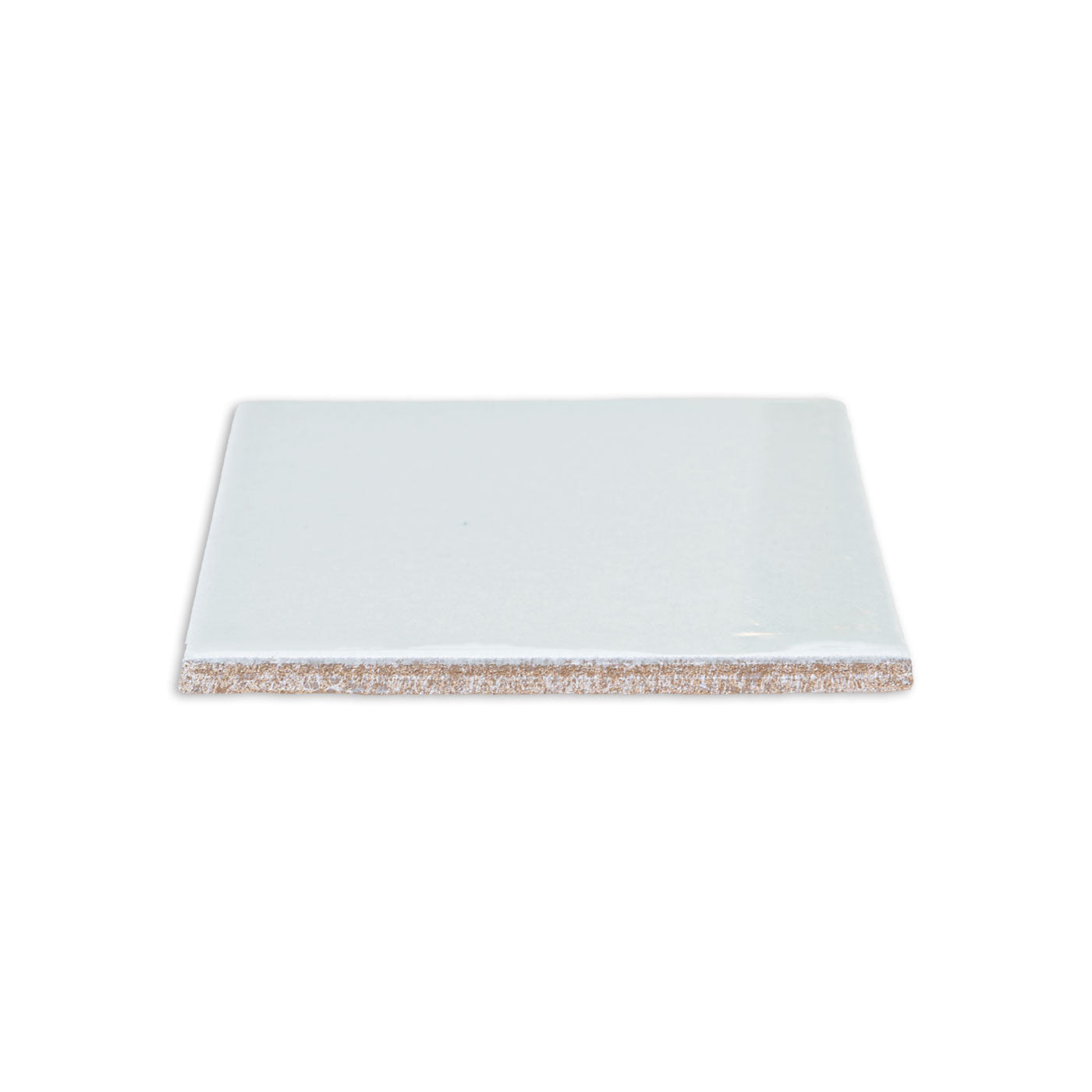 Spearmint 4.25x4.25 solid tile by Clay Imports, showing its smooth, glossy surface and textured brown underside.