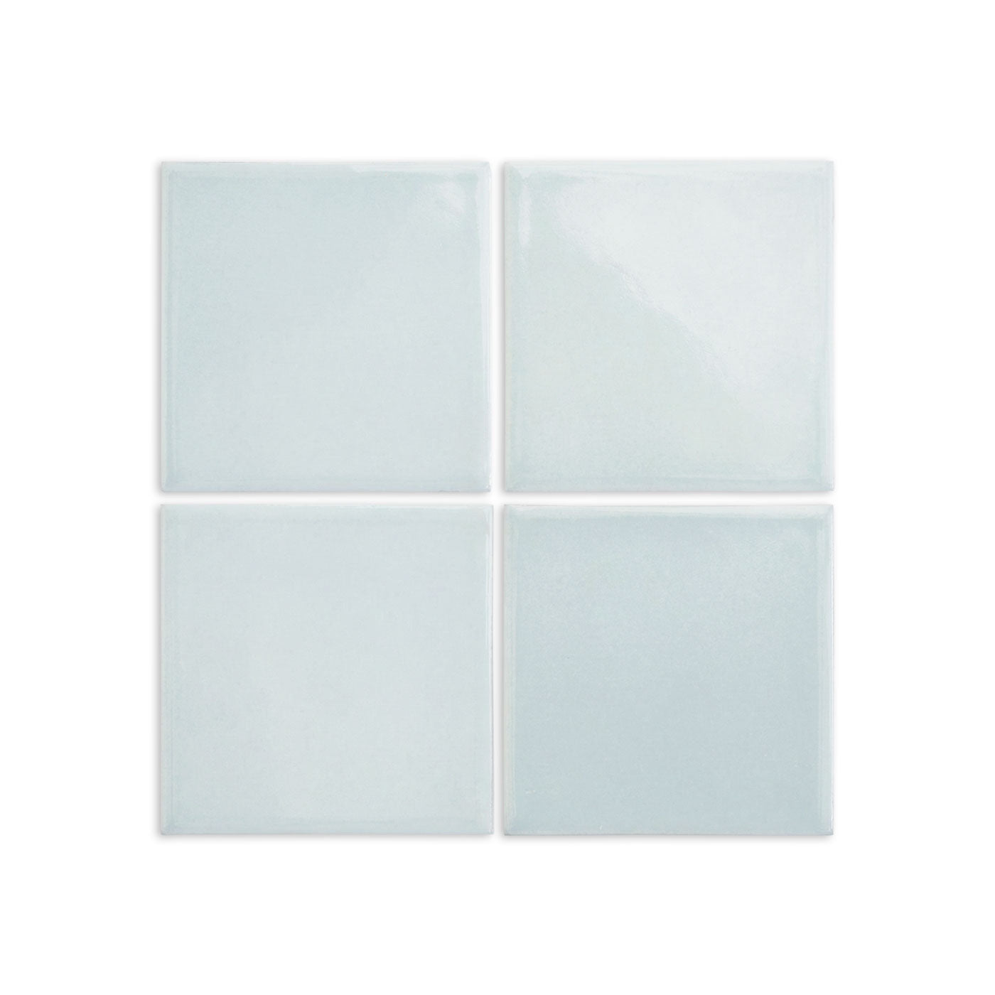 Spearmint solid tile by Clay Imports, featuring four glossy light blue-green squares with subtle texture.