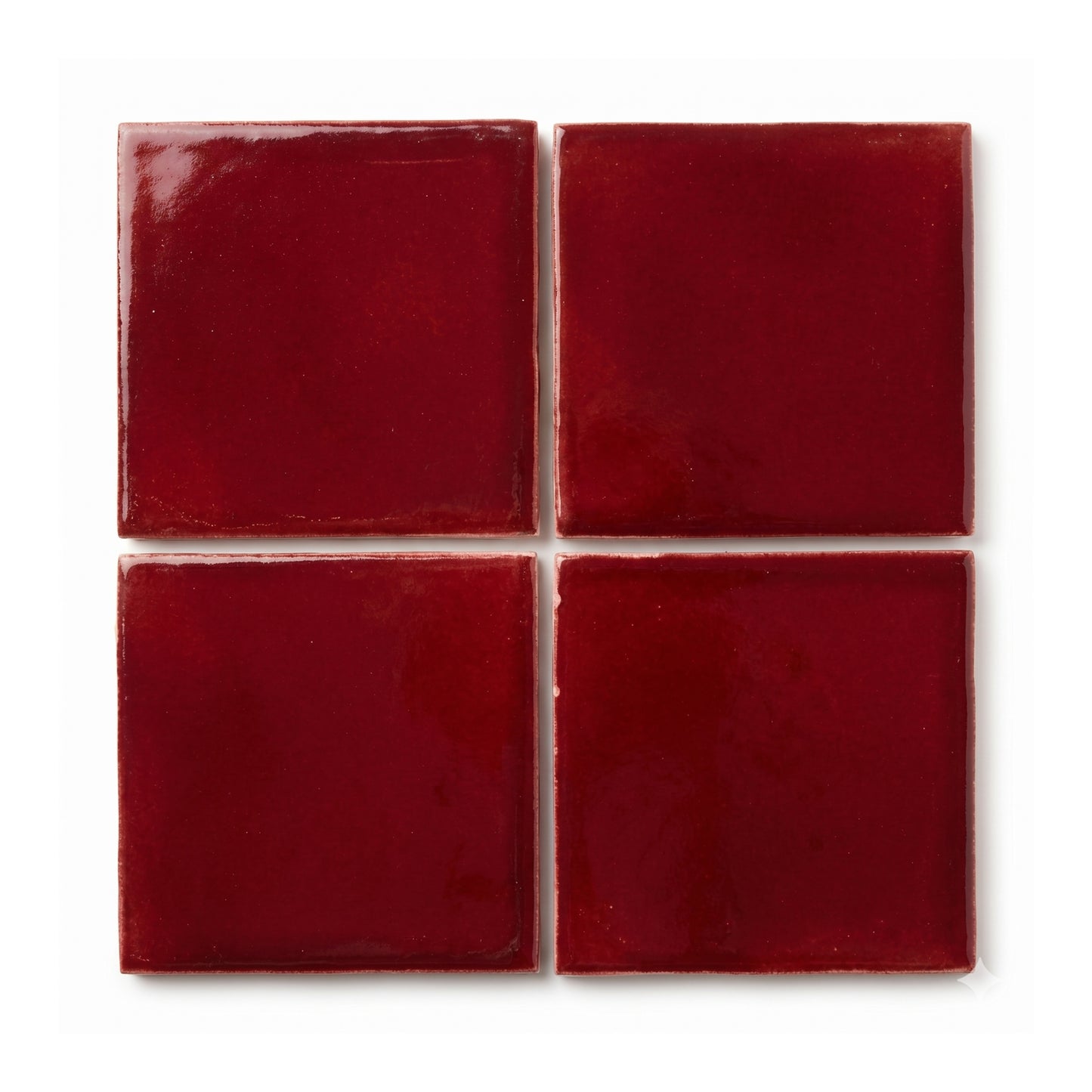 Oxblood red clay tiles by Clay Imports, arranged in a 2x2 grid with glossy, textured surface and uneven edges.