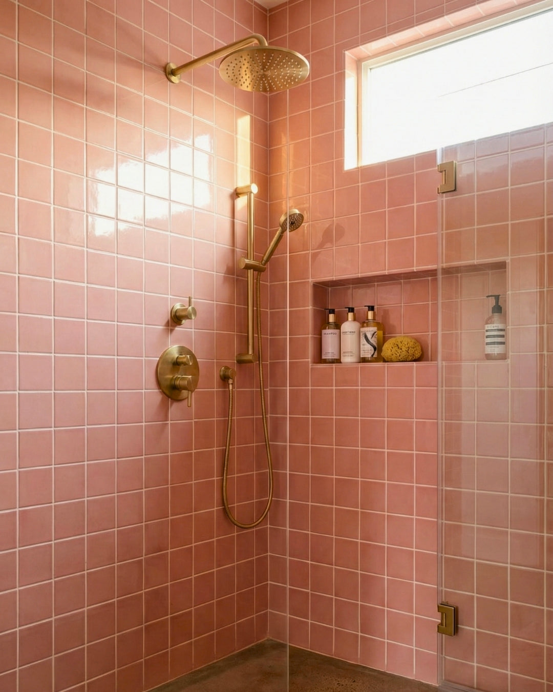Square Peony pink clay tiles by Clay Imports with a glossy finish, installed in a shower with brass fixtures and a window.