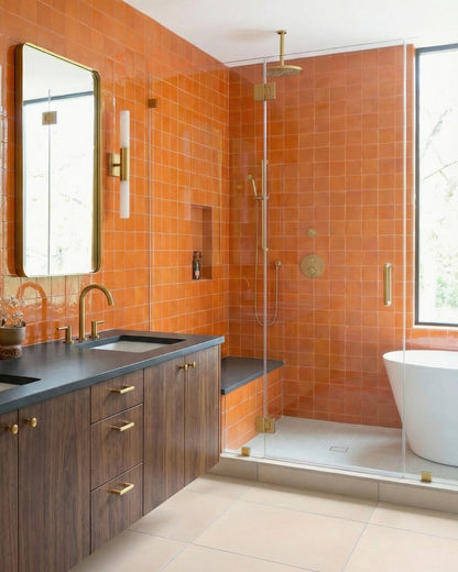 Mandarin 4.25x4.25 clay tiles by Clay Imports covering modern bathroom walls with brass hardware.