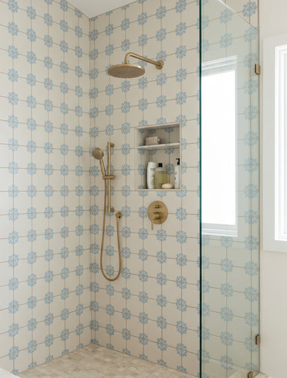 Cream and blue floral patterned Talavera tile by Clay Imports in shower, with gold fixtures and glass enclosure, lifestyle view