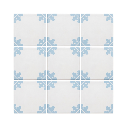 A 3x3 grid of square ceramic tiles with a white background and a light blue ornamental floral pattern in the corners of each tile.