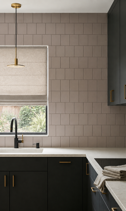 Matte coyote solid tile by Clay Imports, arranged in a stacked pattern as a kitchen backsplash with dark green cabinets and light countertops.