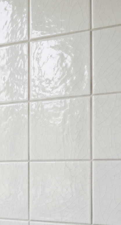 Close-up of white crackle gloss tile by Clay Imports, showing square tiles with subtle grout.