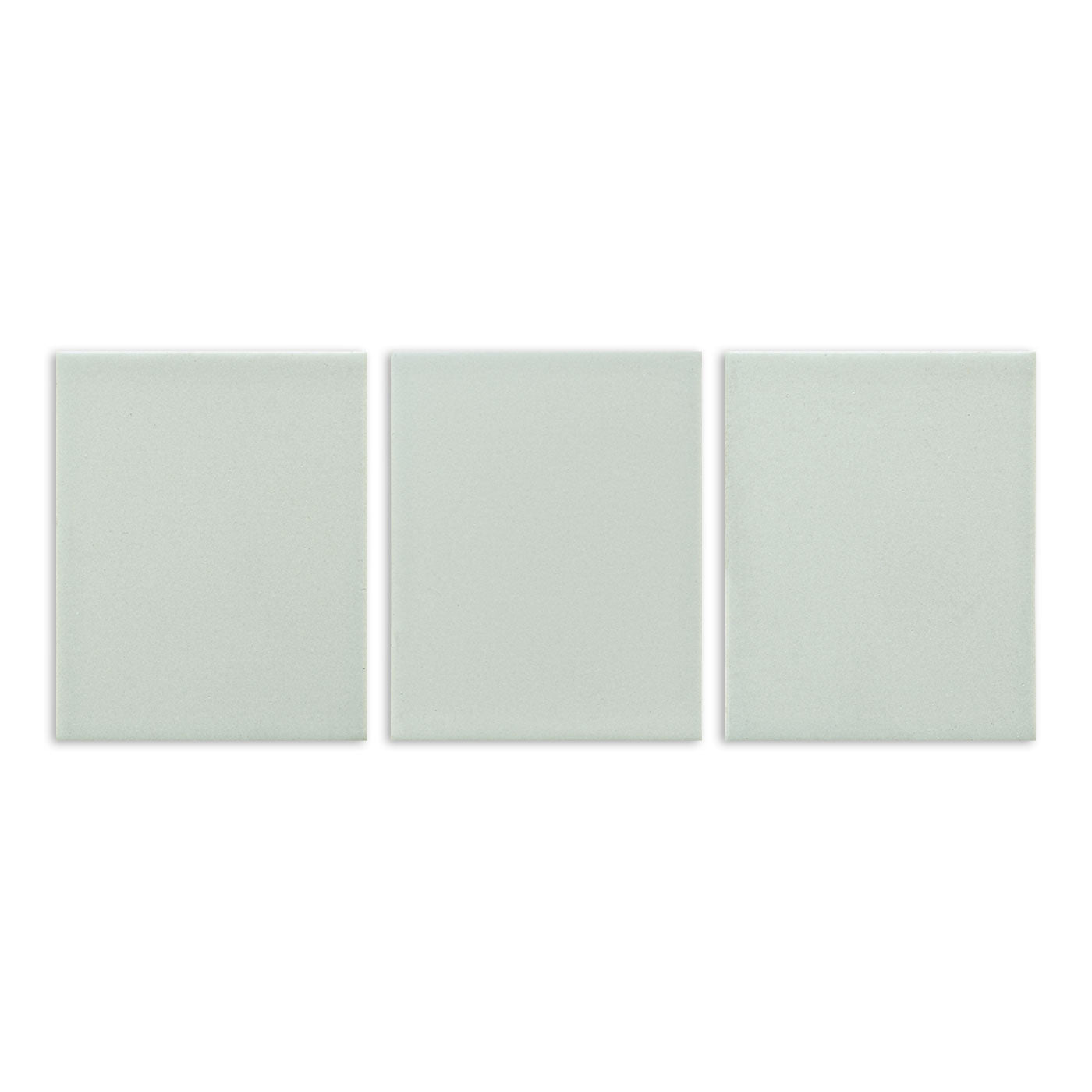 Three pale green matte solid tiles by Clay Imports, arranged side-by-side with a subtle grainy texture.