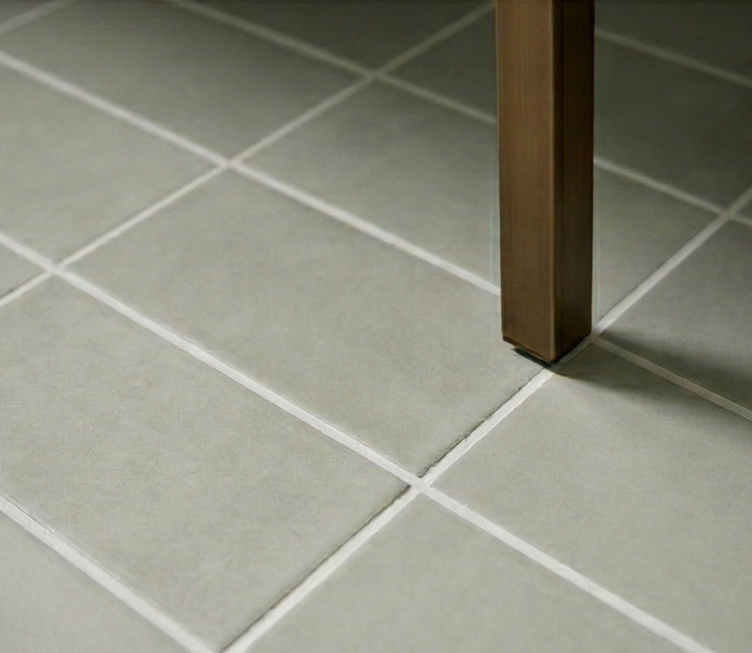 Muted green Agave 4x8 clay tiles by Clay Imports, with white grout lines and a bronze table leg.