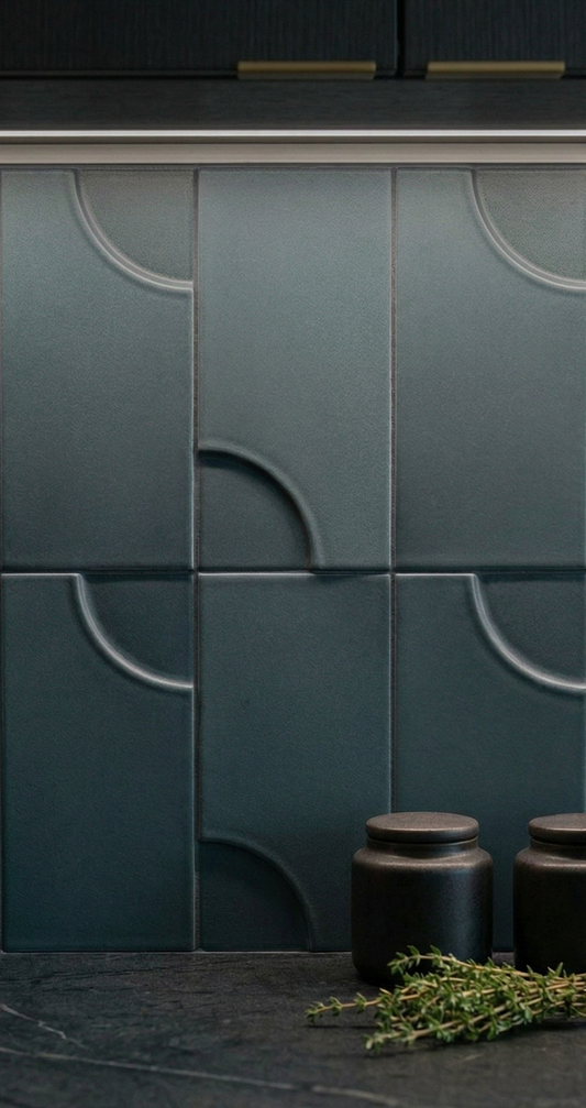 Dark teal ceramic tiles by Clay Imports, featuring embossed quarter-circle patterns, arranged as a kitchen backsplash.