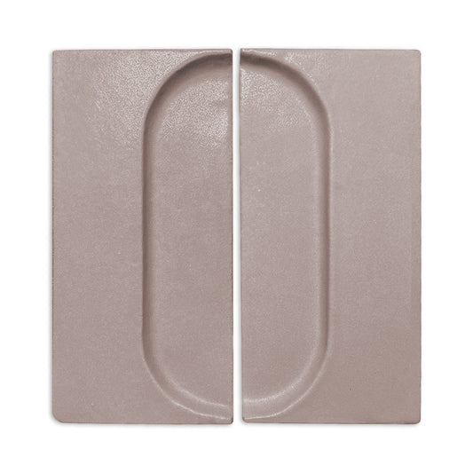 Brown clay tile by Clay Imports with a recessed oval design, shown as two rectangular pieces.
