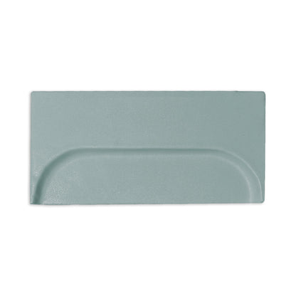 Light sage green 4x8 clay tile by Clay Imports with a central oval embossed design and matte texture.