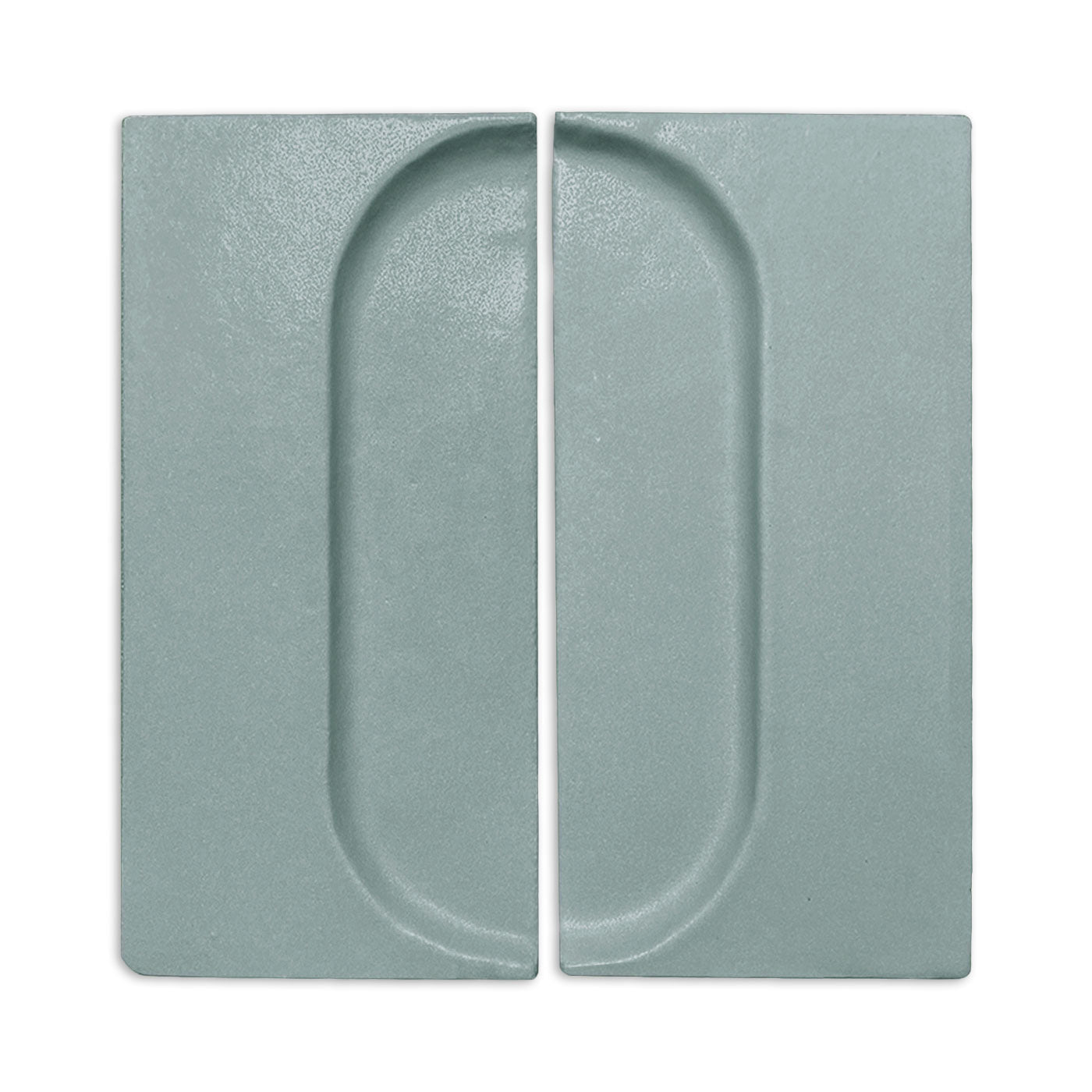 Textured sage green rectangular clay tiles by Clay Imports, each with a recessed half-oval forming a full oval pattern.
