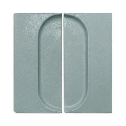 Textured sage green rectangular clay tiles by Clay Imports, each with a recessed half-oval forming a full oval pattern.