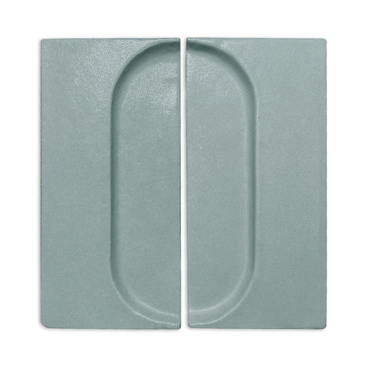 Textured sage green rectangular clay tiles by Clay Imports, each with a recessed half-oval forming a full oval pattern.