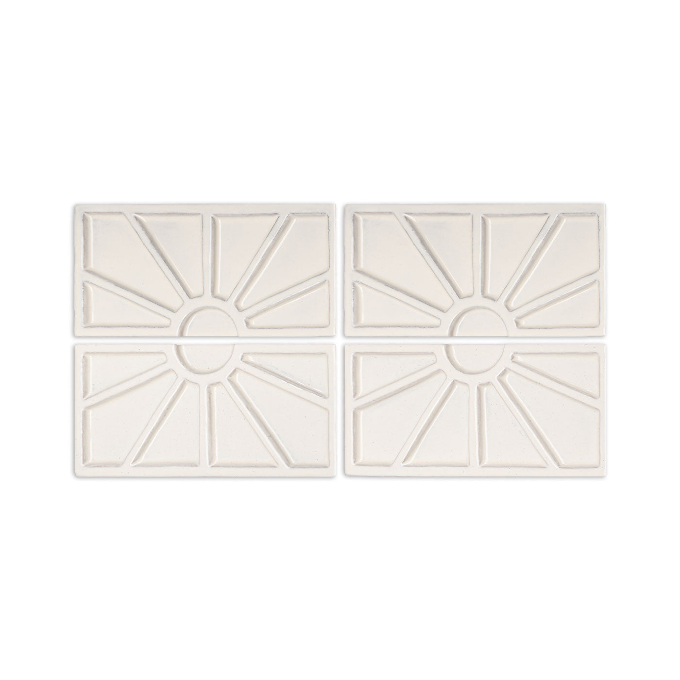 Four off-white Petalito Candela clay tiles by Clay Imports, each featuring a geometric sunburst design.