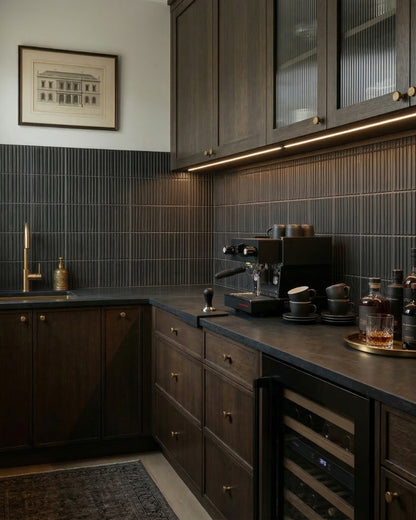 Black suede-textured fluted tiles by Clay Imports forming a stylish kitchen backsplash.