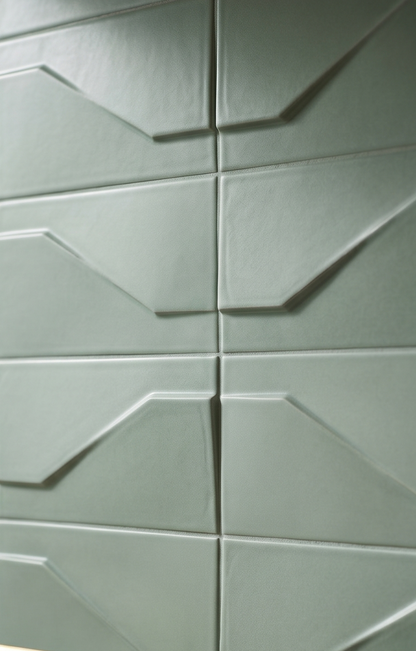 Sage green geometric ceramic tiles by Clay Imports featuring an angular 3D pattern and a subtly textured surface.