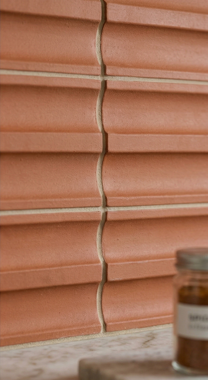 Terracotta Valle Mamey clay tile by Clay Imports with a textured, wavy relief and light grout.